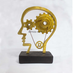 Golden Sculpture of a Human Head with Gears